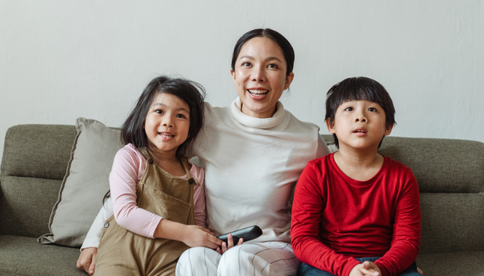 family watching tv on couch